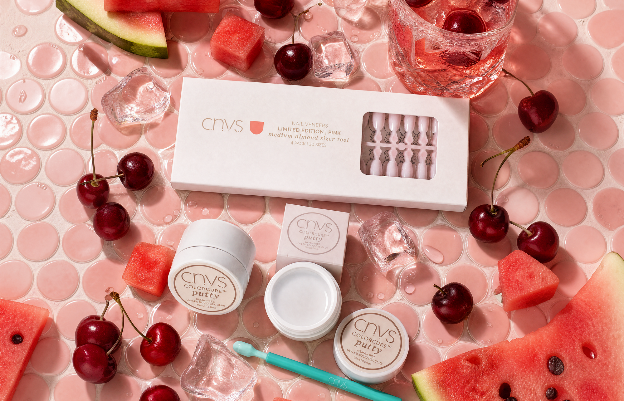 CNVS Nail products with watermelon and cherry on a pink background
