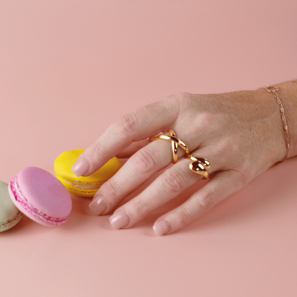 Limited Edition Pink Short Square Nails by CNVS Nails on a woman's posed hand 