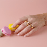 Limited Edition Pink Short Square Nails by CNVS Nails on a woman's posed hand 