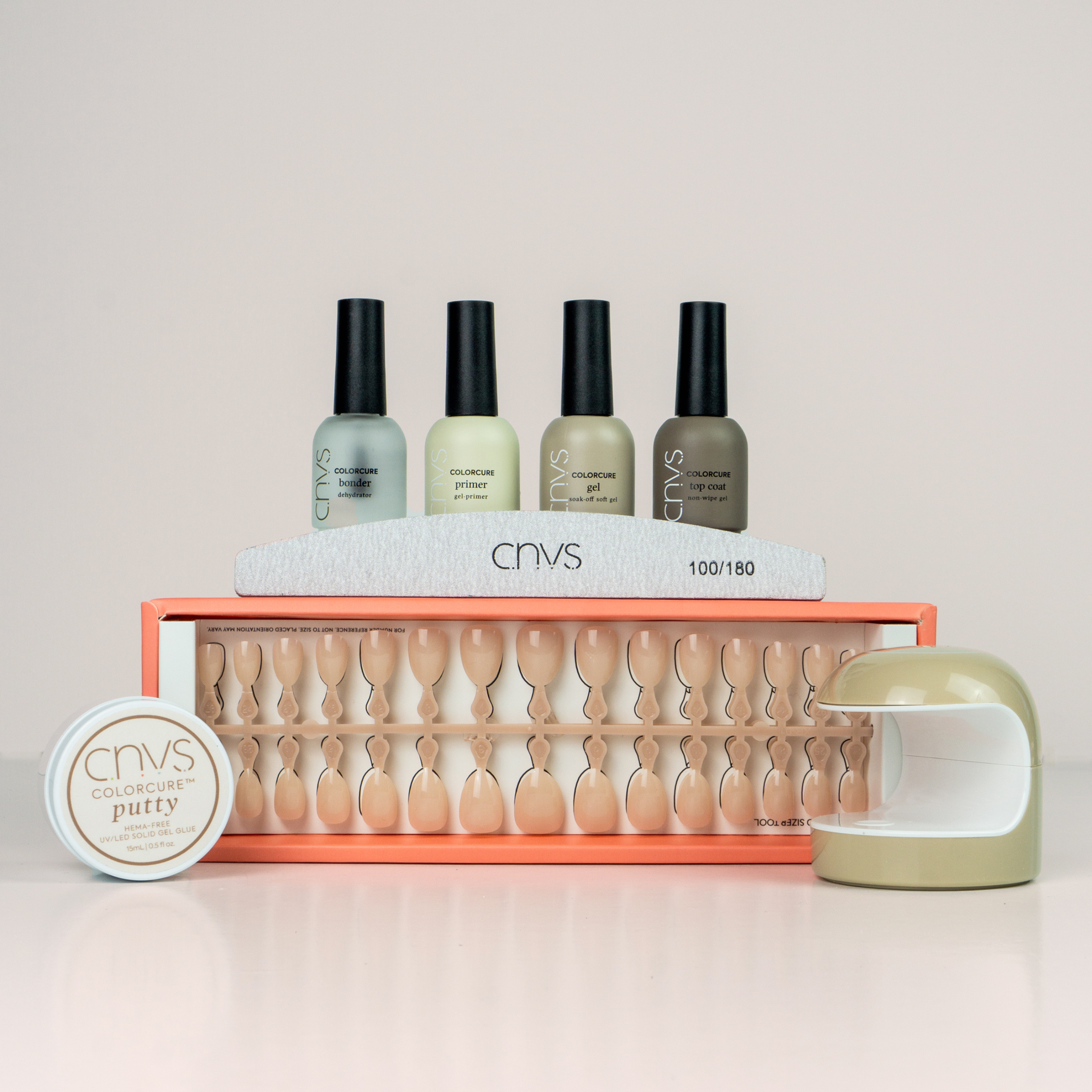 Quick Start Manicure Kit with medium nude almond nails, gel polish, nail glue, and a LED-lamp for nail application by CNVS Nails
