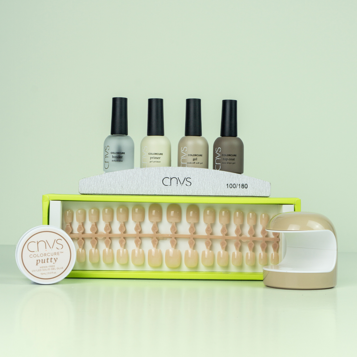 Quick Start Bundle with short nude square nails and application supplies for at-home manicures by CNVS Nails