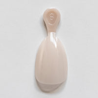 Single usable short nude almond gel nail extension for at-home manicures by CNVS Nails. Used to build a custom-fit manicure set