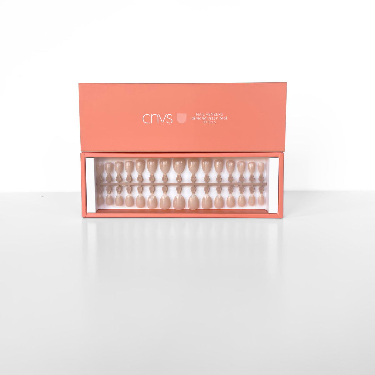 Two Short Nude Almond Nail Sizer Tools with usable gel nail extensions by CNVS Nails