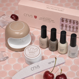 CNVS nail care set with lamp, putty, and nail polishes on a pink background